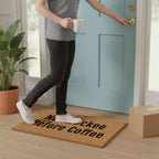 A person wearing a gray shirt and black pants is holding a white mug and stepping onto a door with a mat that says "Naps Before Coffee".