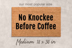 A rectangular door mat with the text "No Knocklee Before Coffee" printed on it.