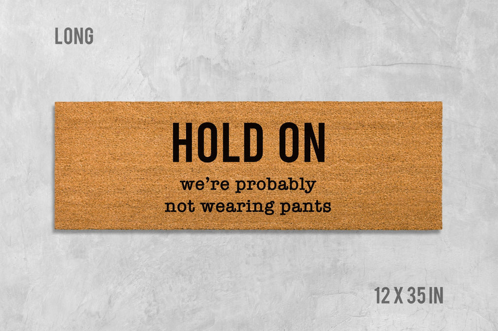 Funny Door Mat: 'Hold On We're Not Wearing Pants' (Housewarming Gift)