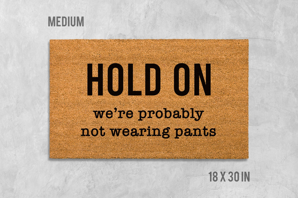 Funny Door Mat: 'Hold On We're Not Wearing Pants' (Housewarming Gift)